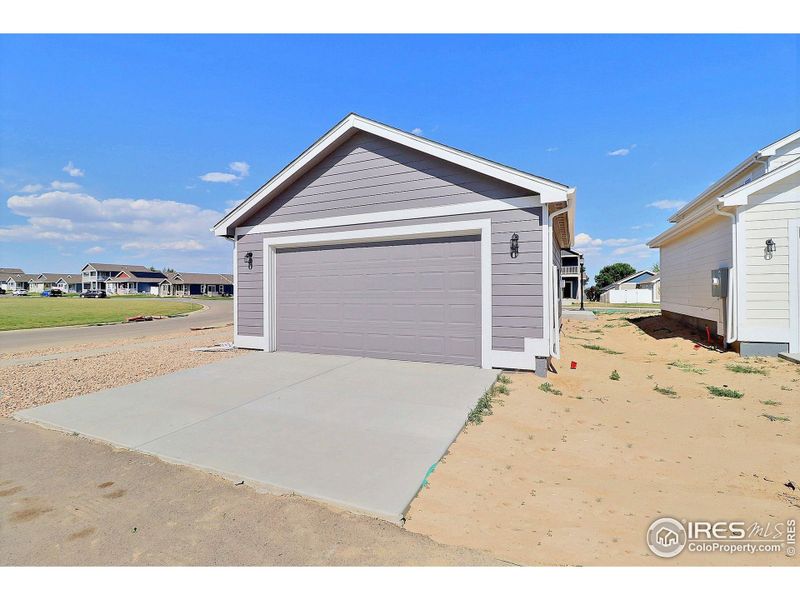 Front exterior of a new home in , Evans, CO, highlighting curb appeal (Image 21).