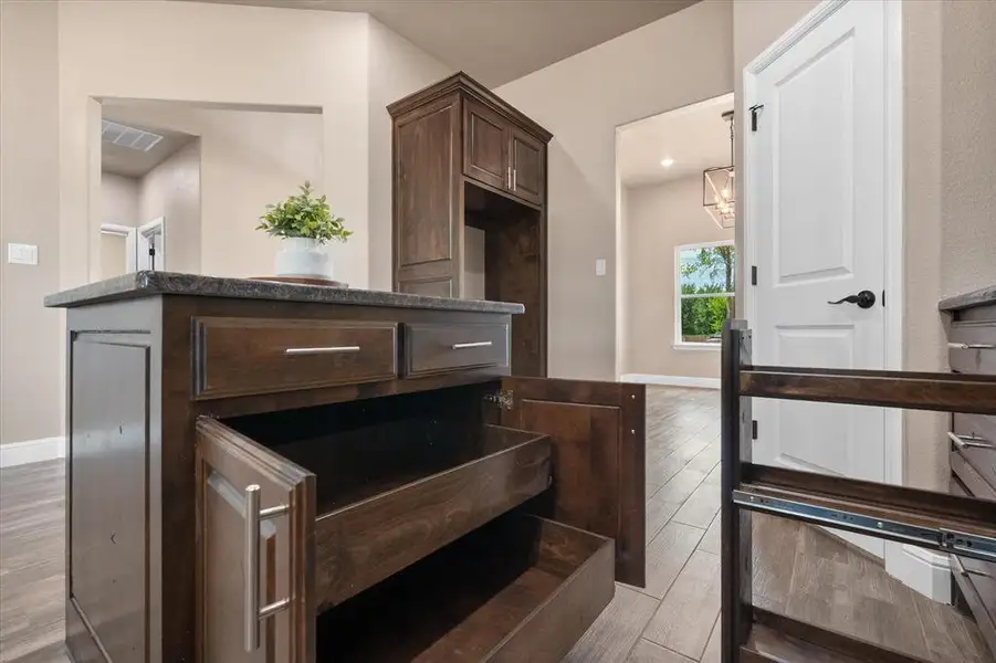 Unique kitchen cabinets featuring pull out shelves and a pull out spice rack