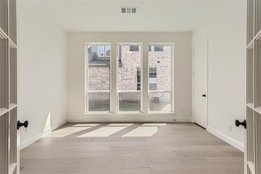 Spare room featuring light wood-type flooring