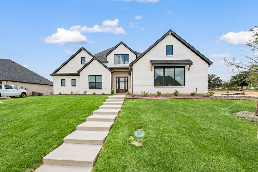 Front exterior of a new home in Highland Oaks, Boyd, TX, highlighting curb appeal (Image 1).