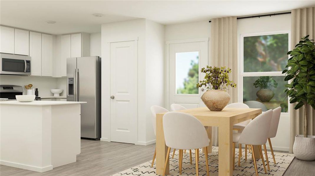 Kitchen featuring white cabinetry, light hardwood / wood-style flooring, and appliances with stainless steel finishes