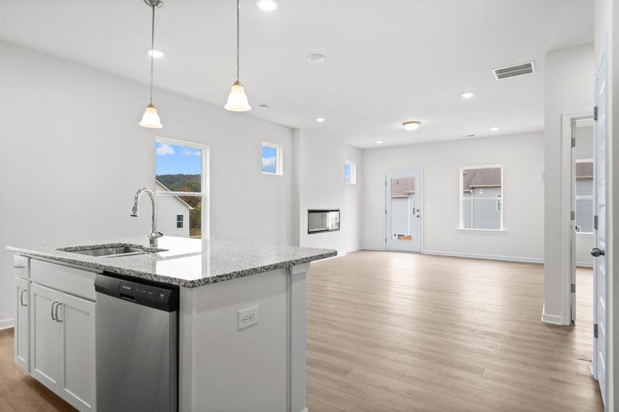 The Dove- Kitchen into the Family Room. Home under construction, photo used for illustrative purposes only, colors and options will vary.