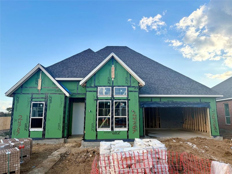 The front exudes curb appeal with its elegant architectural lines, complemented by a fresh, vibrant palette that catches the eye.