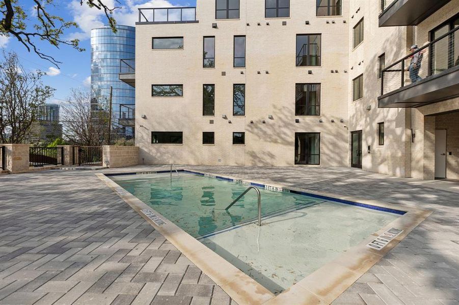 View of pool featuring a patio and fence