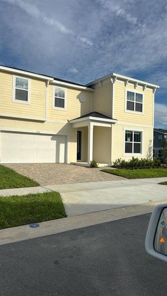 Front exterior of a new home in Solara Resort, Kissimmee, FL, highlighting curb appeal (Image 2).