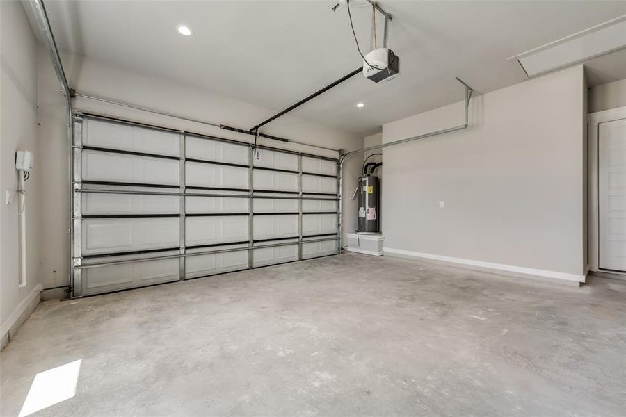 Garage with water heater and a garage door opener