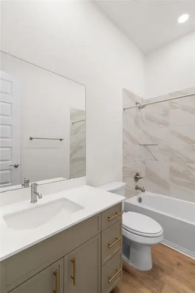 A bathroom features a modern vanity with ample storage and a combination shower/tub. A bathroom features a modern vanity with ample storage and a combination shower/tub.