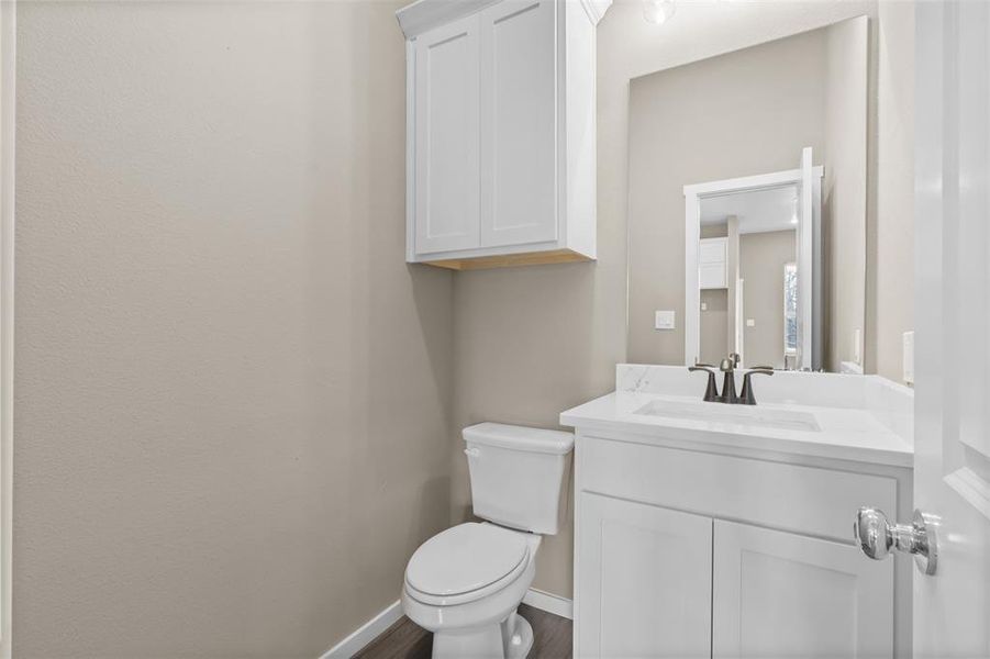 Bathroom with vanity, wood-type flooring, and toilet