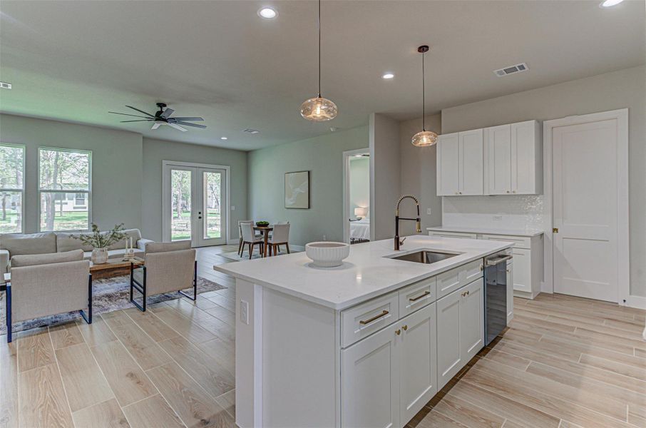 Kitchen with a sink, open floor plan, recessed lighting, stainless steel dishwasher, and white soft close cabinets.