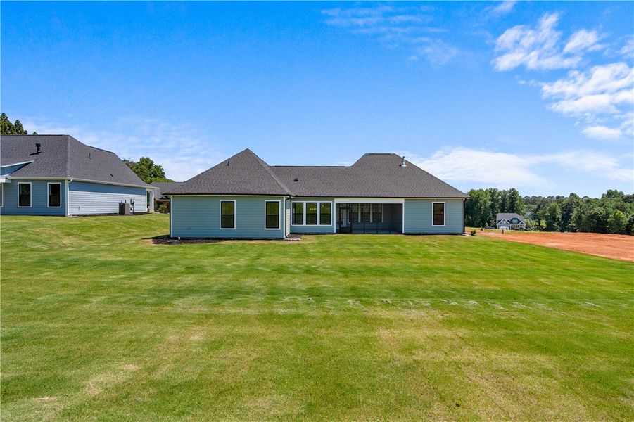 A sprawling lawn offers generous space behind this A sprawling lawn offers generous space behind this