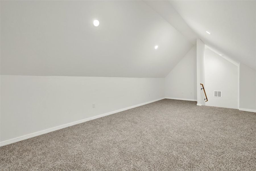 Additional living space with carpet, lofted ceiling, and recessed lighting