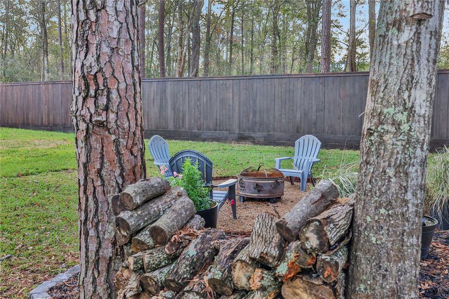 REAL wood firepit in the back already has a stack. Privacy fence encloses the entire back yard! Keep the fur babies and tiny humans safely inside!