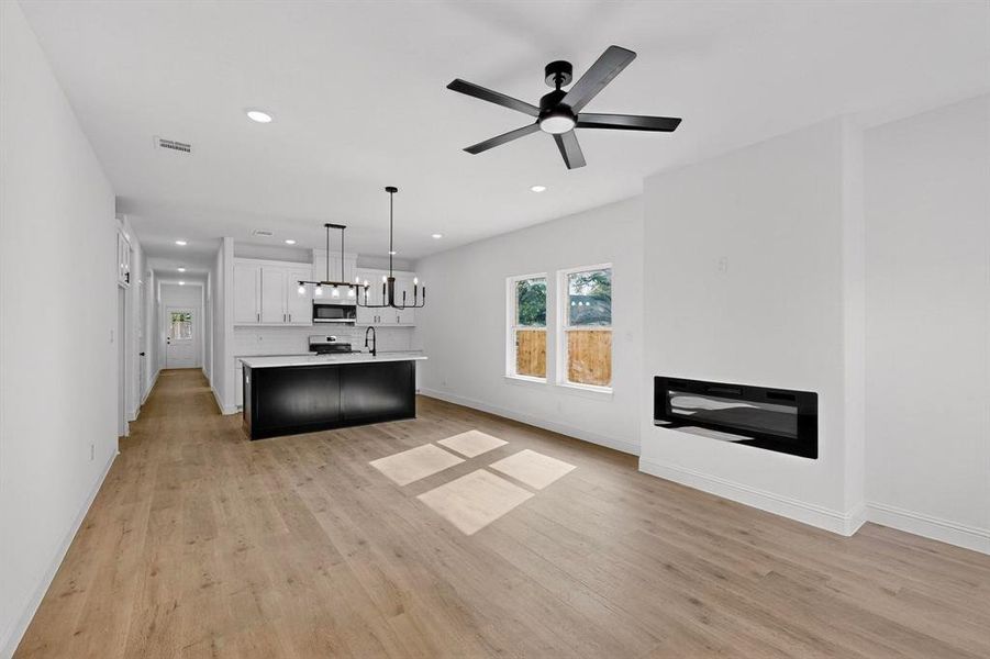 Unfurnished living room featuring light wood-style floors, recessed lighting, and ceiling fan