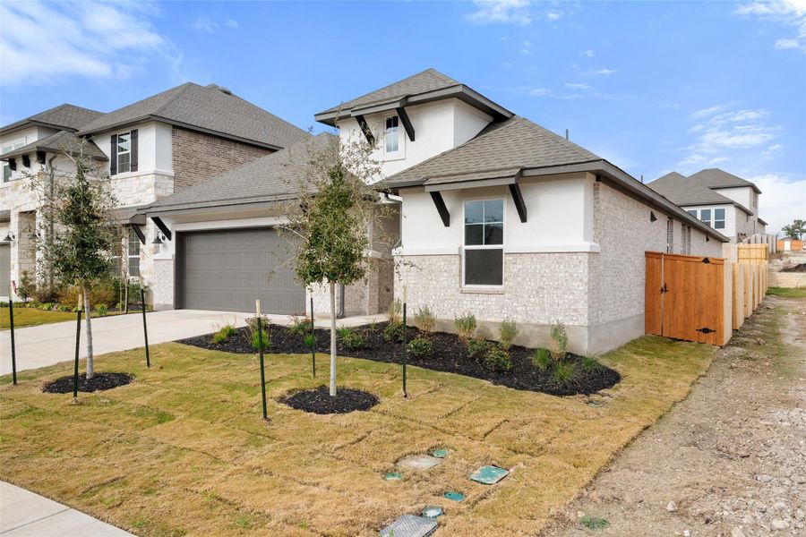 Front exterior of a new home in Lariat, Liberty Hill, TX, highlighting curb appeal (Image 2). Front exterior of a new home in Lariat, Liberty Hill, TX, highlighting curb appeal (Image 2).
