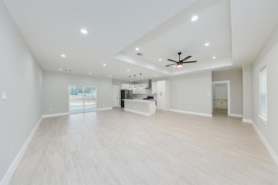 Living room featuring stylish wood-like floors, adding warmth and elegance to the space while enhancing durability.