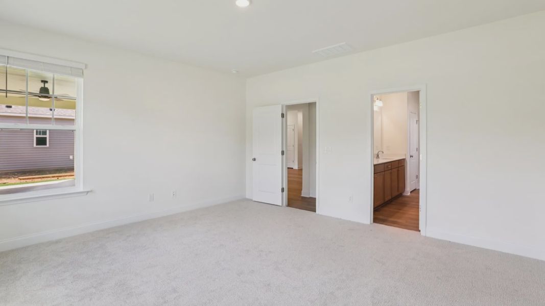 Pendleton home plan spacious first floor primary bedroom/suite with windows and attached bath