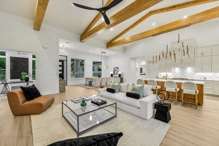 Living area featuring ceiling fan, light wood-type flooring, recessed lighting, and lofted ceiling