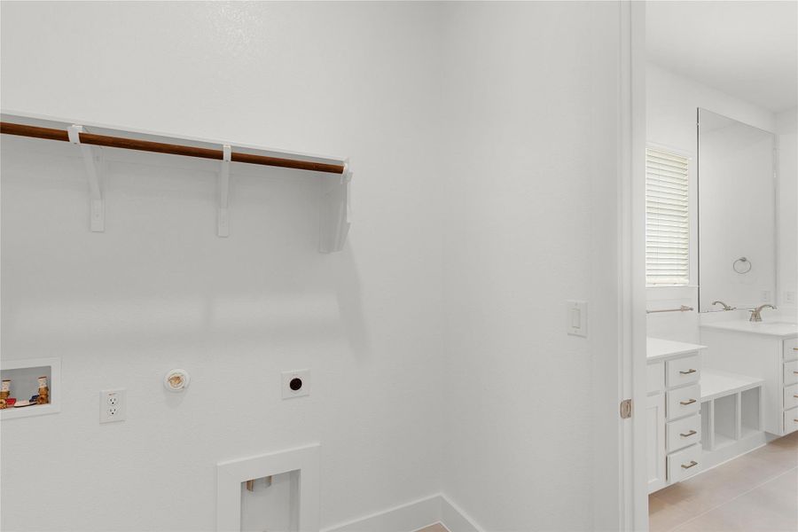 Laundry area with gas dryer hookup, washer hookup, and hookup for an electric dryer