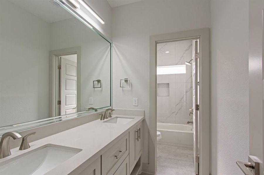 secondary bathroom with double sinks and soft closing cabinetry.