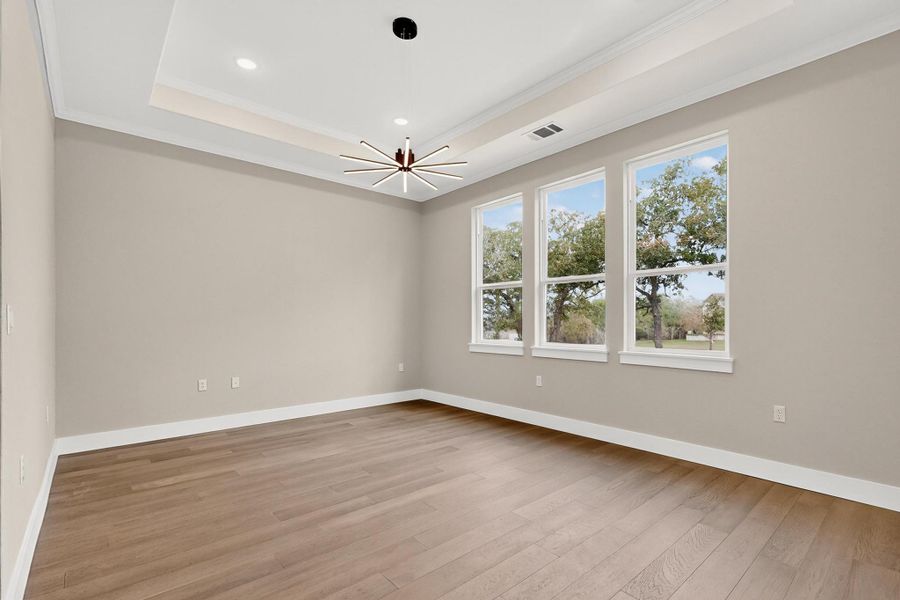 Dining room with wood flooring, crown molding, recessed lighting Dining room with wood flooring, crown molding, recessed lighting