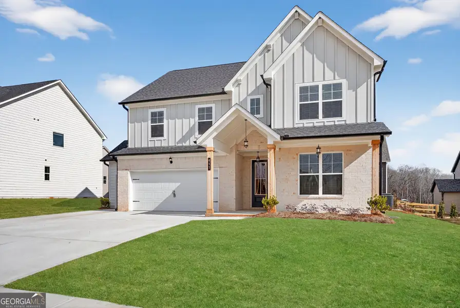Front exterior of a new home in The Fairways at Mirror Lake, Villa Rica, GA, highlighting curb appeal (Image 2). Front exterior of a new home in The Fairways at Mirror Lake, Villa Rica, GA, highlighting curb appeal (Image 2).