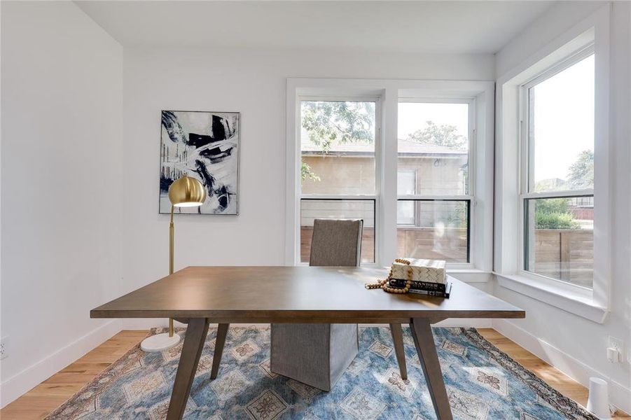 Office area with hardwood / wood-style flooring