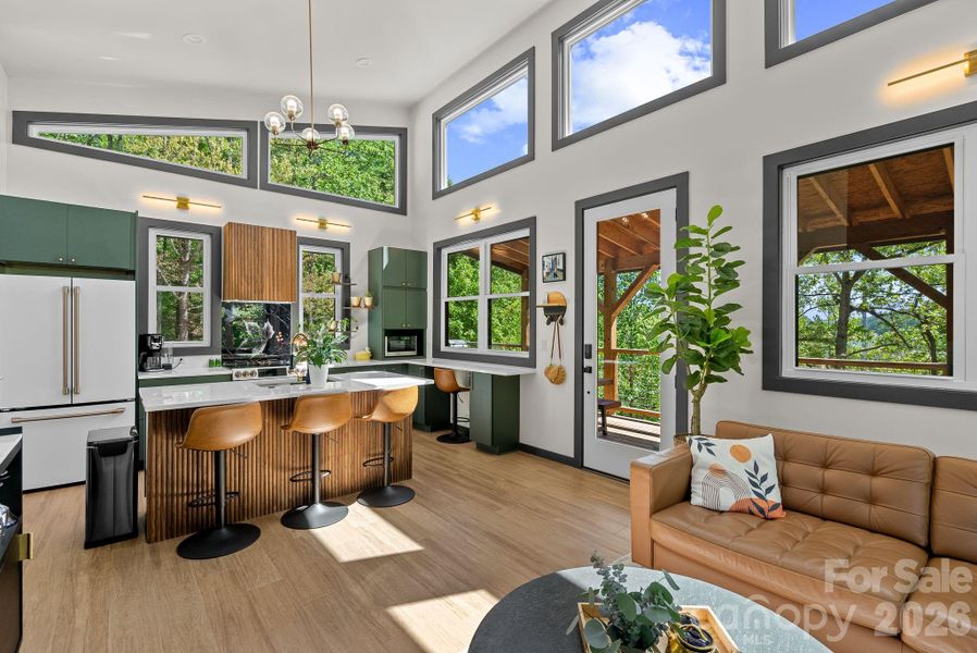 Surrounded by views of sky, trees, river, lake and mountains, this bright airy home is ensconced in nature.