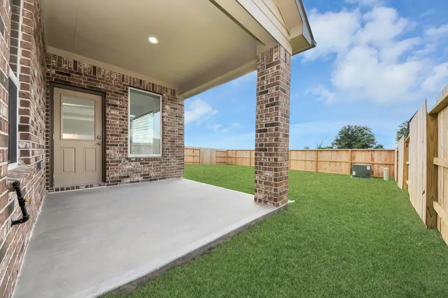 Experience outdoor living at its finest on this expansive covered patio, thoughtfully designed for BBQs and delightful outdoor dining.