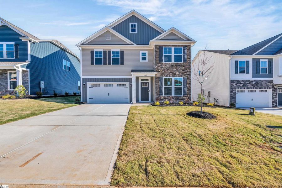 Front exterior of a new home in Halton Oaks, Spartanburg, SC, highlighting curb appeal (Image 18).