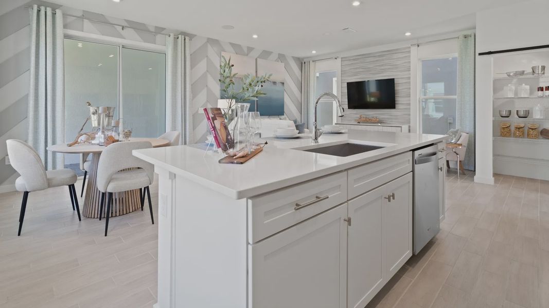 Open kitchen and breakfast area at a DRB Homes Ambersweet model at the Trinity Place community. Open kitchen and breakfast area at a DRB Homes Ambersweet model at the Trinity Place community.