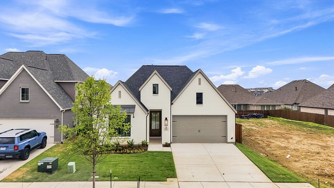 Front exterior of a new home in Tavolo Park, Fort Worth, TX, highlighting curb appeal (Image 25).