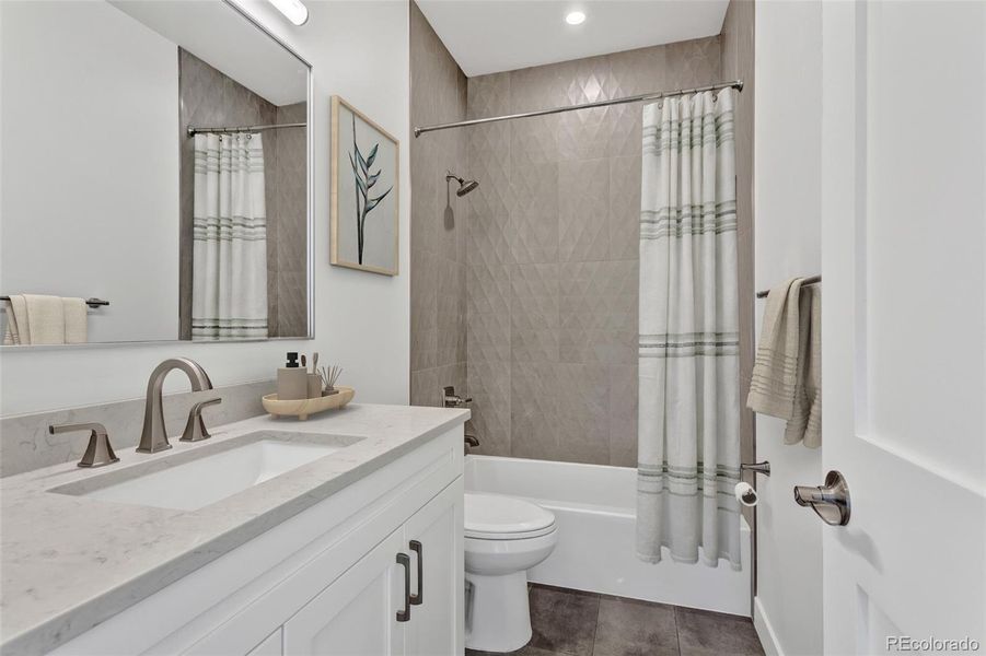 Indulge in a bathroom that rivals a boutique retreat. High-end finishes abound, from the sleek quartz vanity and brushed nickel fixtures to the custom floor-to-ceiling tile work in the shower. The thoughtful palette of earthy neutrals and modern textures provides a calming environment for your daily wellness ritual. Indulge in a bathroom that rivals a boutique retreat. High-end finishes abound, from the sleek quartz vanity and brushed nickel fixtures to the custom floor-to-ceiling tile work in the shower. The thoughtful palette of earthy neutrals and modern textures provides a calming environment for your daily wellness ritual.