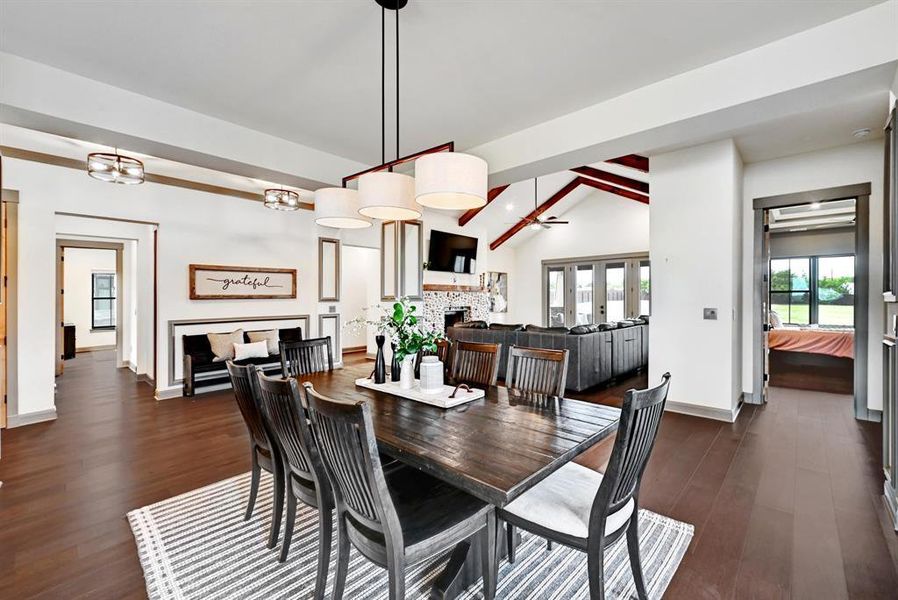 Dining room with a fireplace and dark wood-style floors