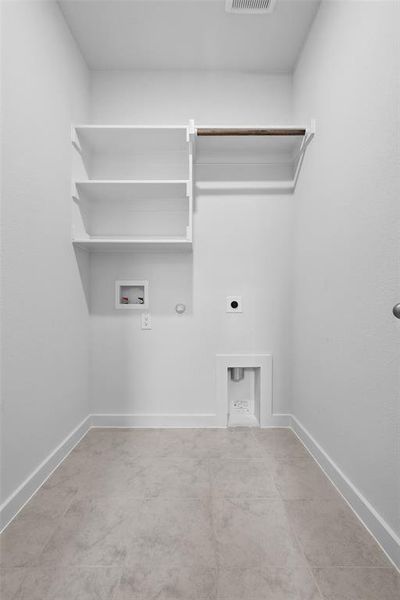 Laundry area featuring hookup for a gas dryer, washer hookup, electric dryer hookup, and baseboards Laundry area featuring hookup for a gas dryer, washer hookup, electric dryer hookup, and baseboards