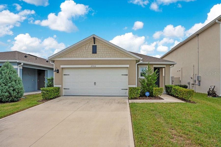 Front exterior of a new home in Harmony West, St. Cloud, FL, highlighting curb appeal (Image 2). Front exterior of a new home in Harmony West, St. Cloud, FL, highlighting curb appeal (Image 2).