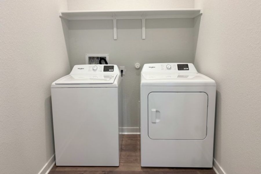 A white machine with a white shelf.