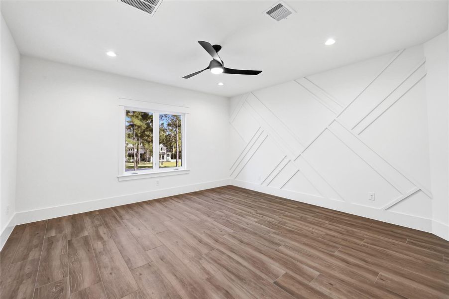 Bedroom Five featuring a custom accent wall.