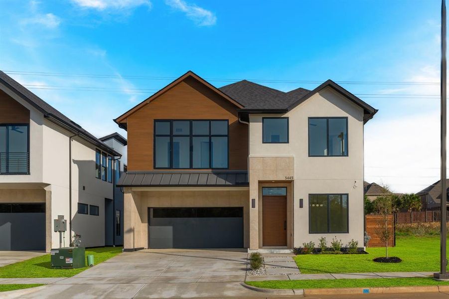 Contemporary house with concrete driveway, a standing seam roof, a metal roof, an attached garage, and stucco siding Contemporary house with concrete driveway, a standing seam roof, a metal roof, an attached garage, and stucco siding