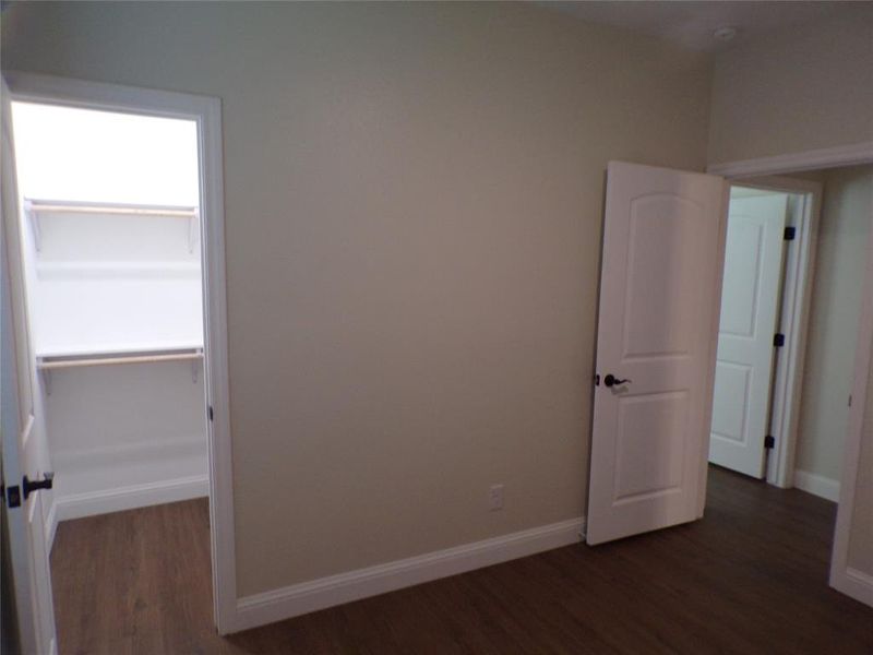 3rd bedroom featuring dark wood-type flooring