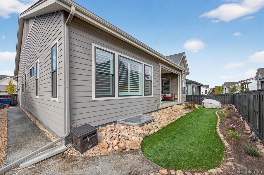 Backyard (Angle 2) – Side and rear yard with easy-care landscaping and a clean layout designed for outdoor enjoyment with minimal upkeep.