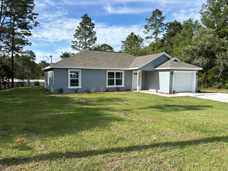 Front exterior of a new home in , Dunnellon, FL, highlighting curb appeal (Image 17).