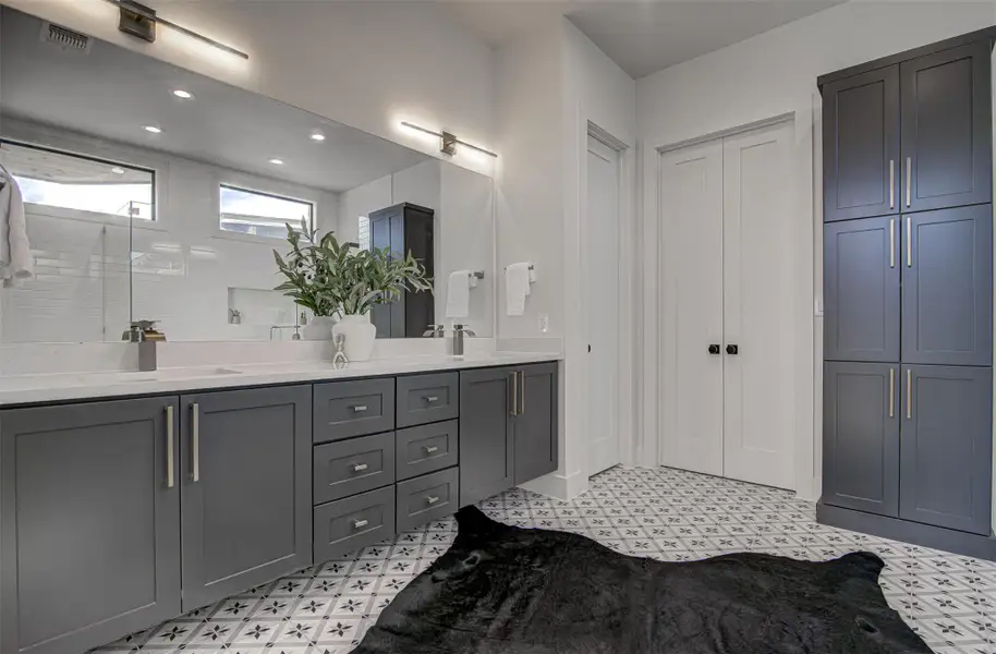 Bathroom with tile patterned floors, a closet, double vanity, and recessed lighting Bathroom with tile patterned floors, a closet, double vanity, and recessed lighting