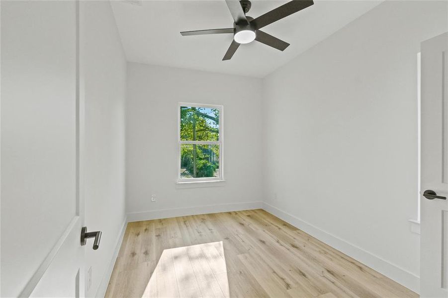 Unfurnished room with light hardwood / wood-style floors and ceiling fan