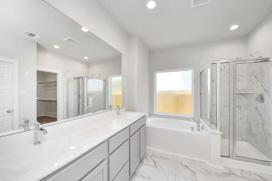 Escape to a spa-like oasis in this primary bathroom. Sample photo of completed home with similar plan. Actual colors and selections may vary. Call for more info.