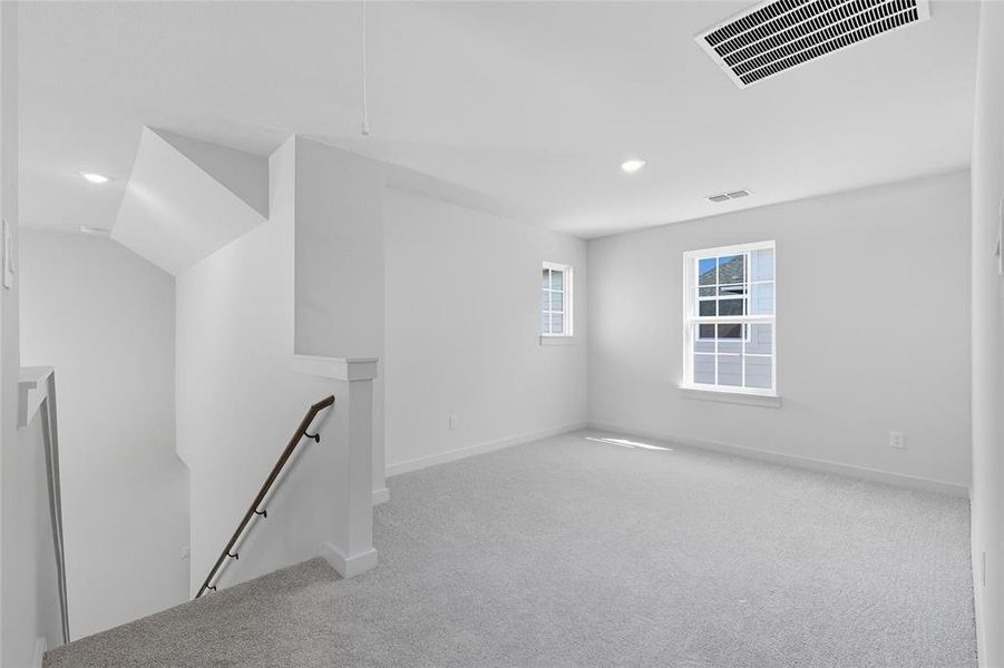 Unfurnished room featuring light colored carpet and recessed lighting Unfurnished room featuring light colored carpet and recessed lighting