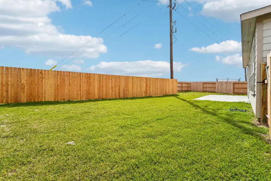 Views of the backyard green space and fully fenced yard.