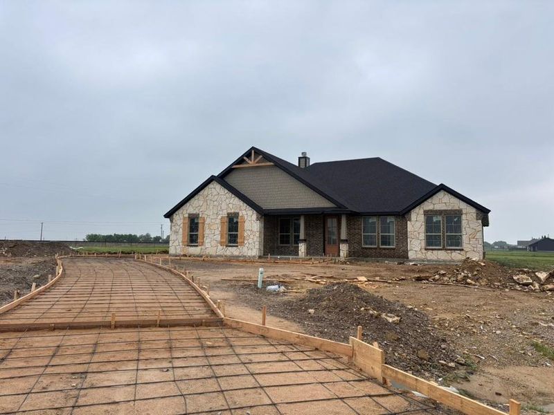 New construction home featuring a stone and brick facade