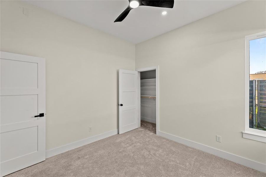Unfurnished bedroom with carpet, a closet, and ceiling fan