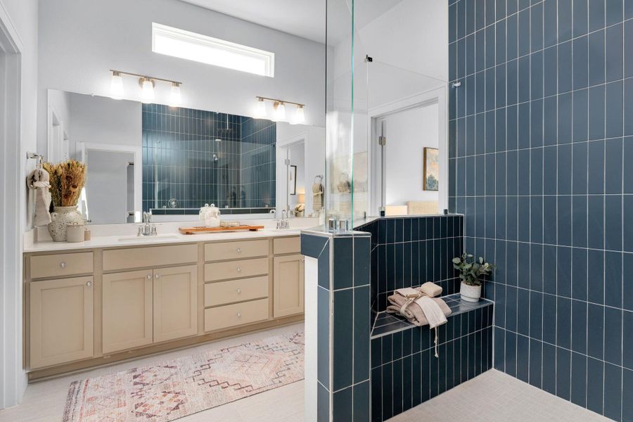Bathroom featuring a walk in shower and double vanity Bathroom featuring a walk in shower and double vanity