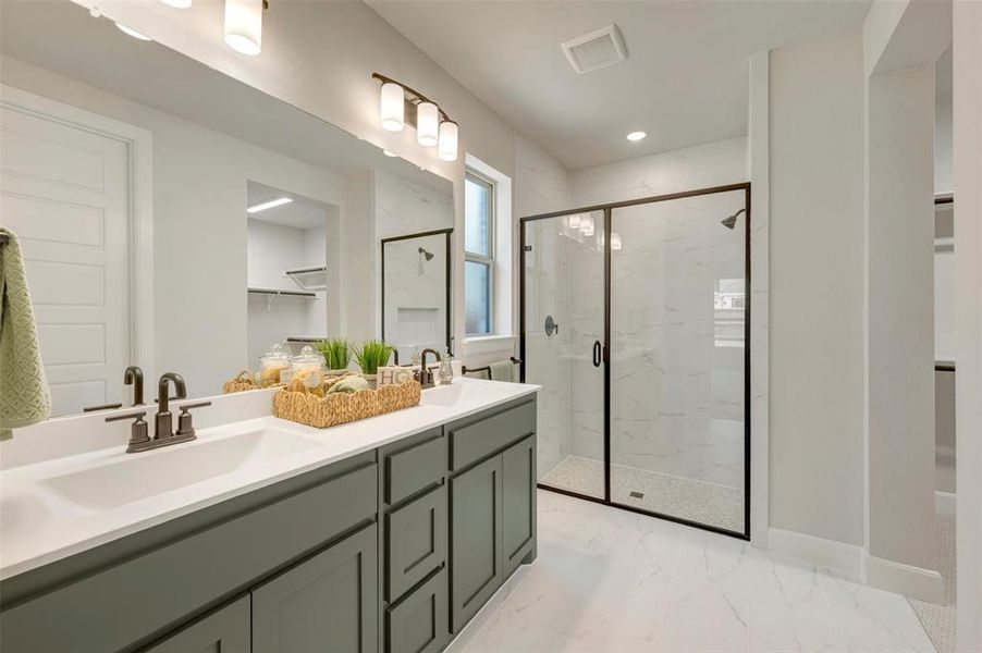 Double vanity with white countertops, undermount sinks, and dark bronze-finish fixtures